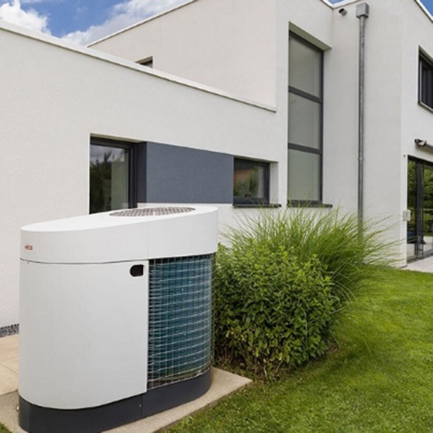 Modern single-family home with a heat pump in the garden